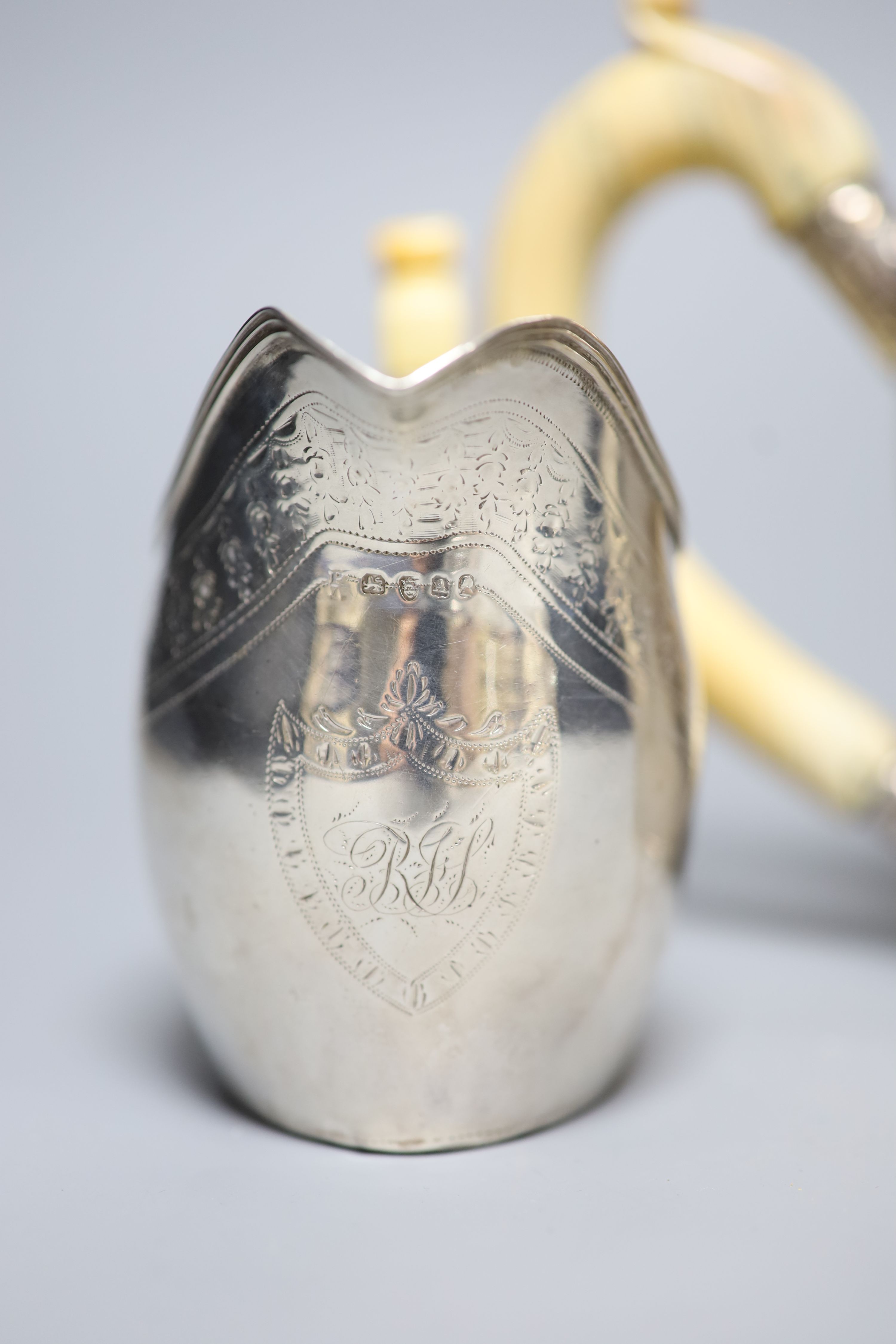 A George III silver teapot, with ivory handle, Henry Green, London, 1795 and a similar cream jug, London, 1796, (a.f.)